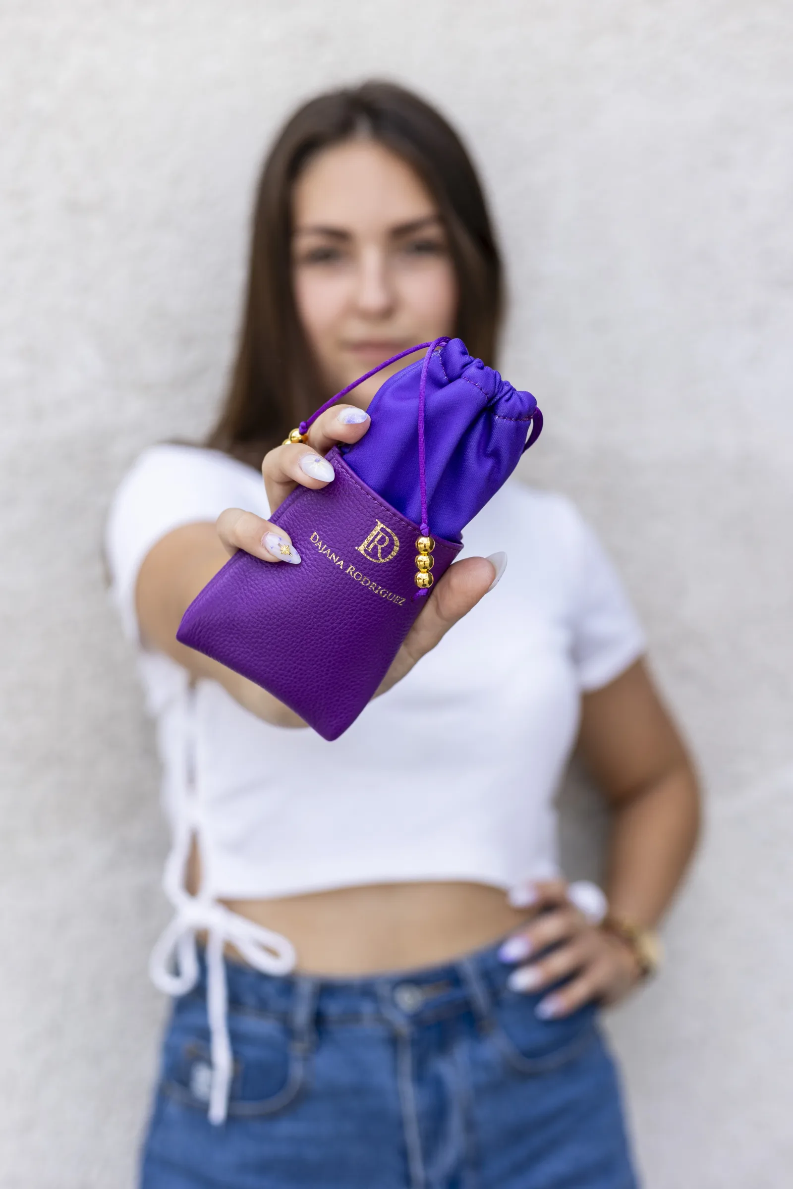 Dajana Rodriguez leather pouch held up to camera