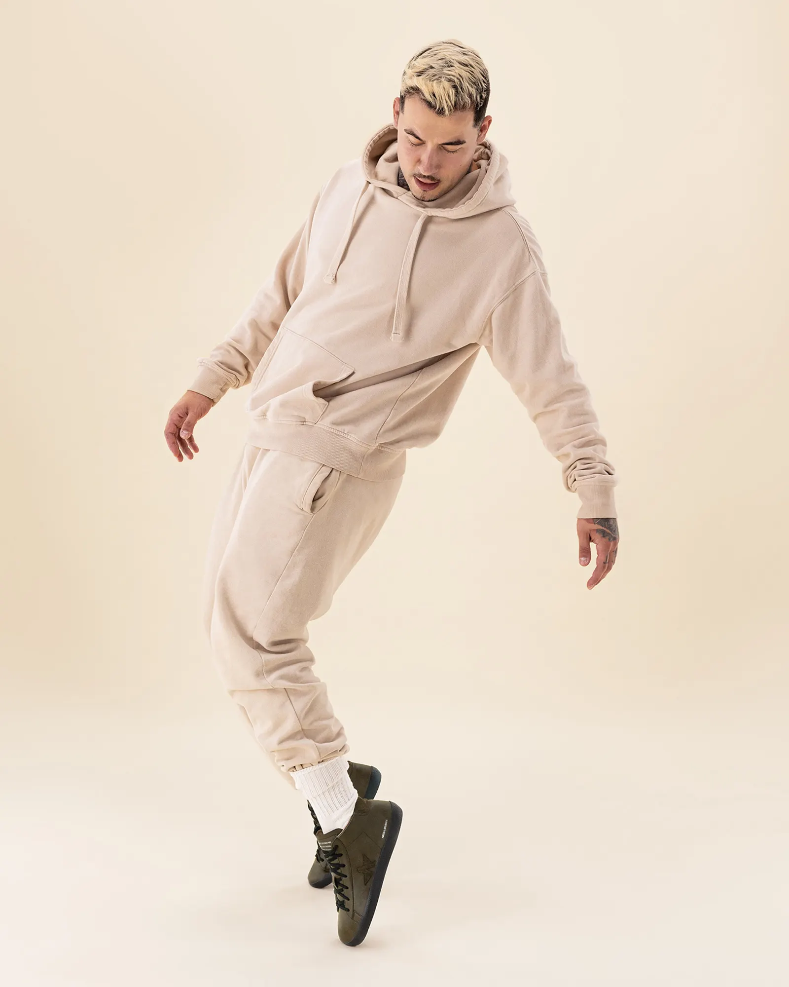 Lookbook shot — beige hoodie, neutral tones